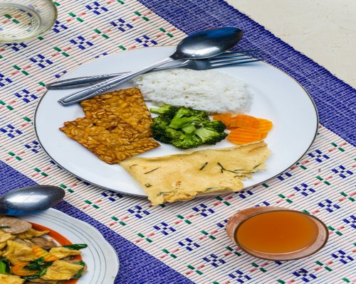 A simple Indonesian homemade meal with clear vegetable soup and fried tempeh